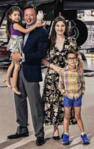 Nick Tran Family Photo in Front of Planes